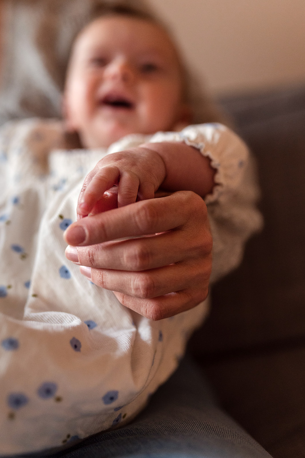 hand of a baby in the hand of her mother