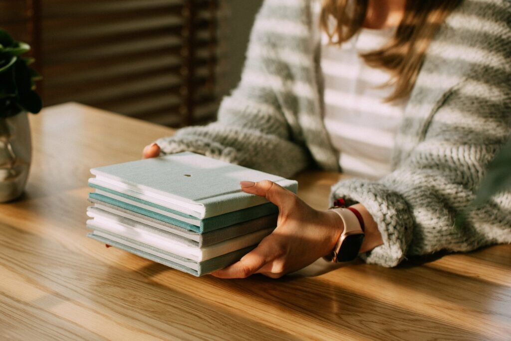 woman holding photo albums