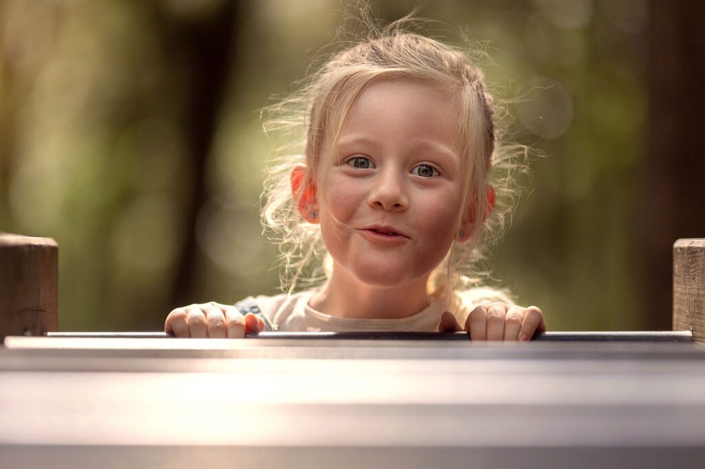 Little girl is smiling in the park during an outdoor photoshoot