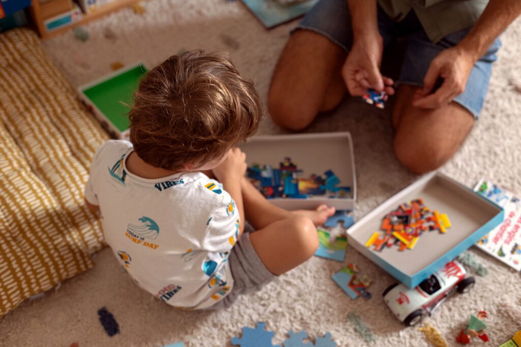 dad playing puzzle with son, fun family activities for your next photo session