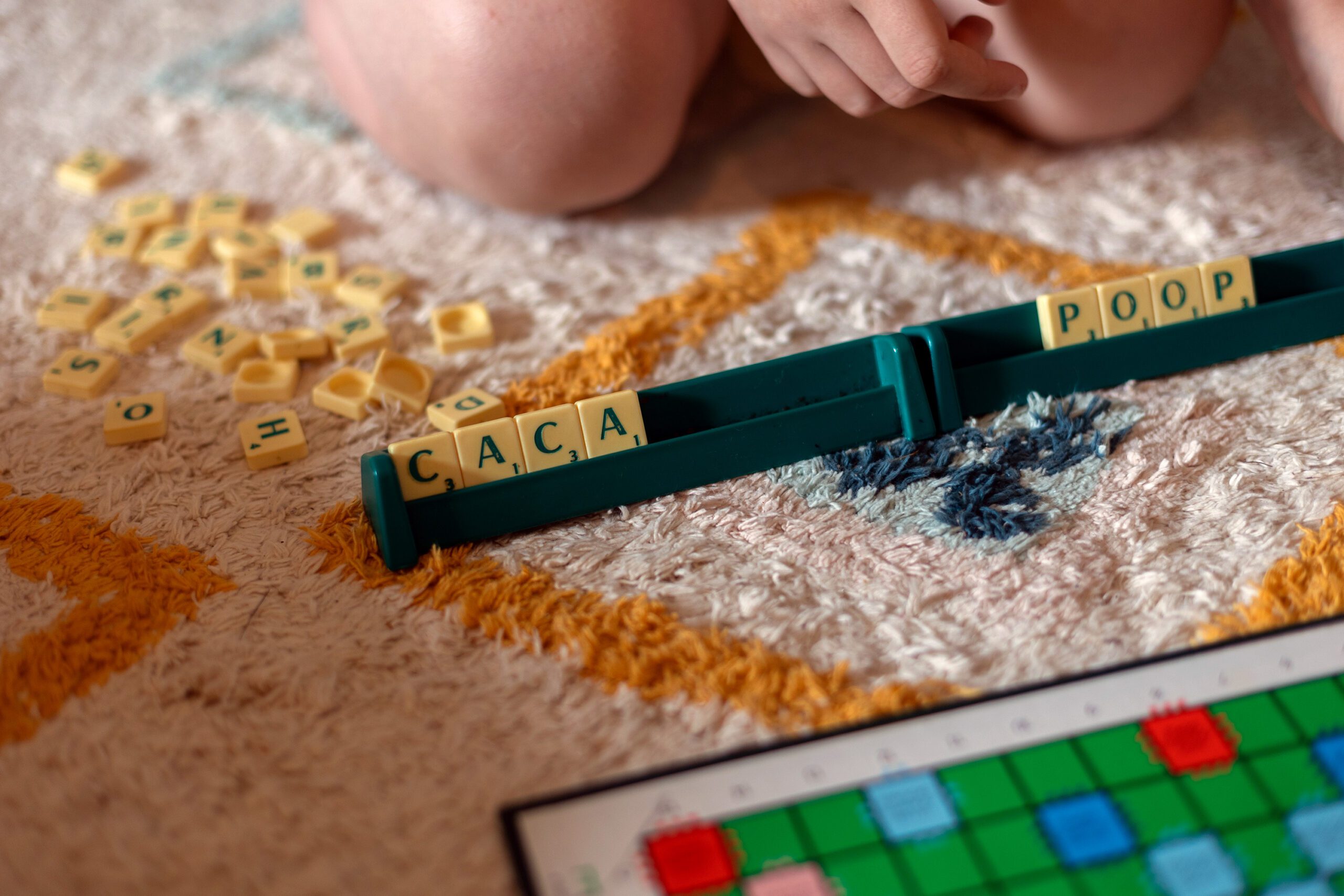 Child playing a word game on the floor at home