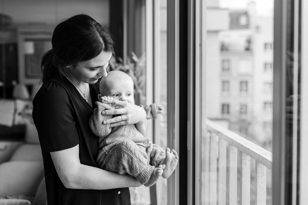 mother and baby looking out the window