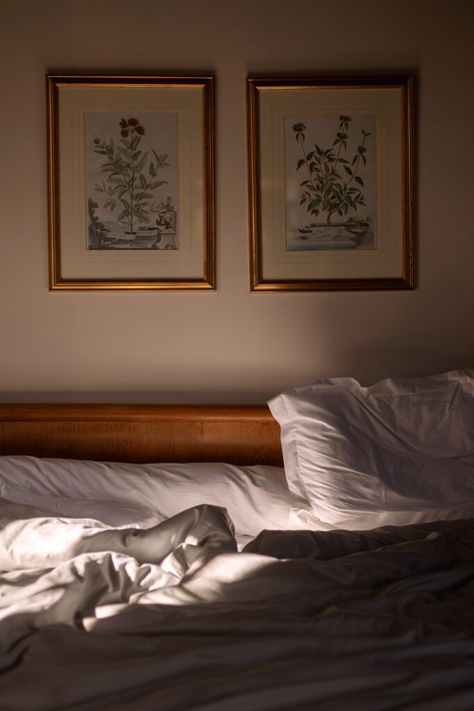 Morning sunlight falling across an unmade bed