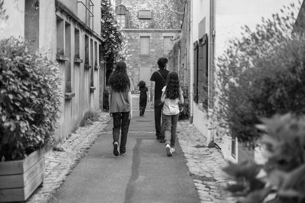 Family walking through a quiet street during a trip