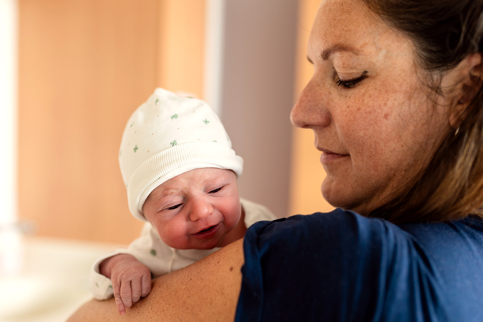 a mother holding her tiny newborn