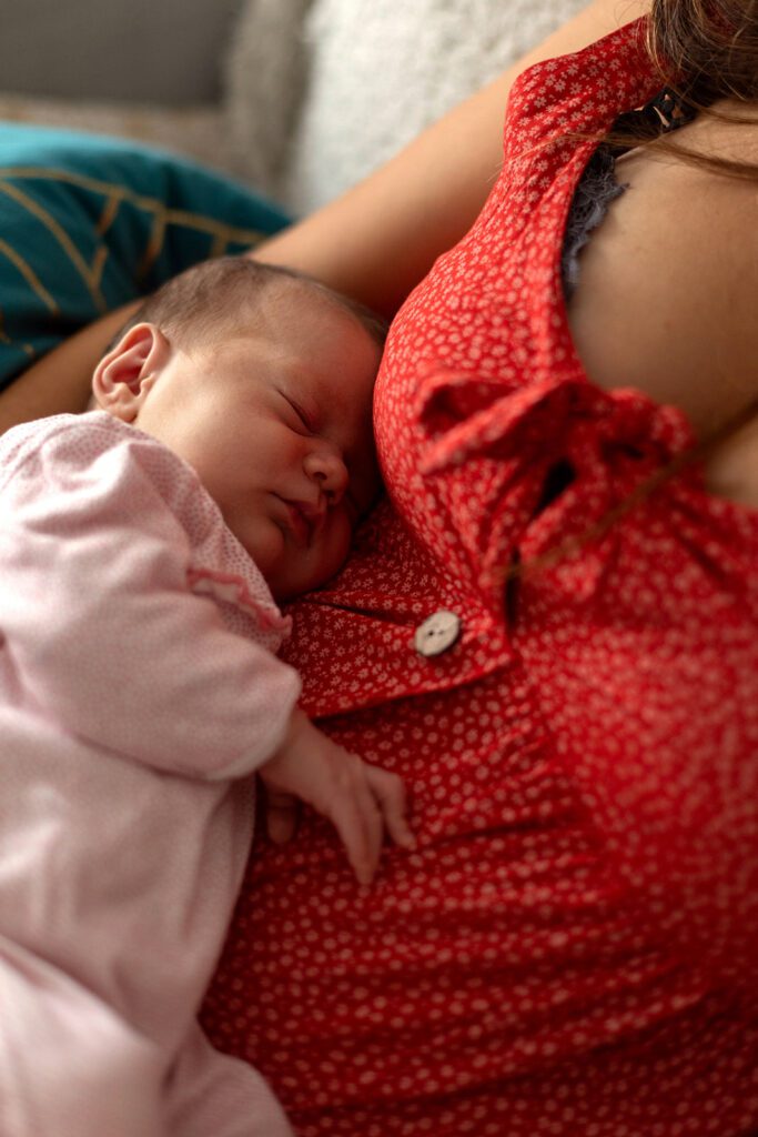 a newborn sleeping on his mother's belly