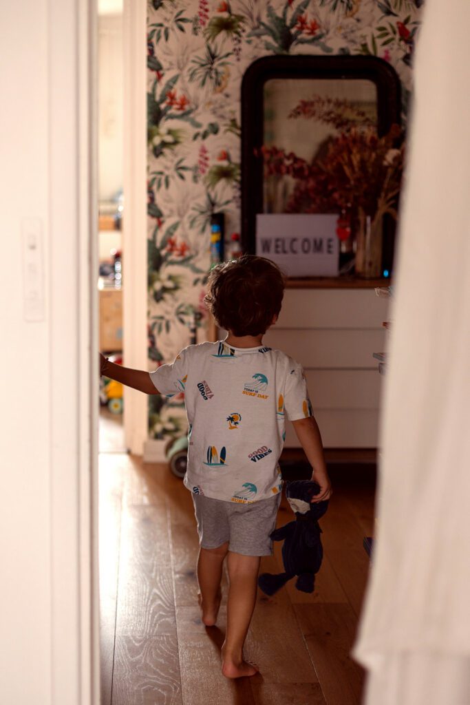 little boy walking in his home