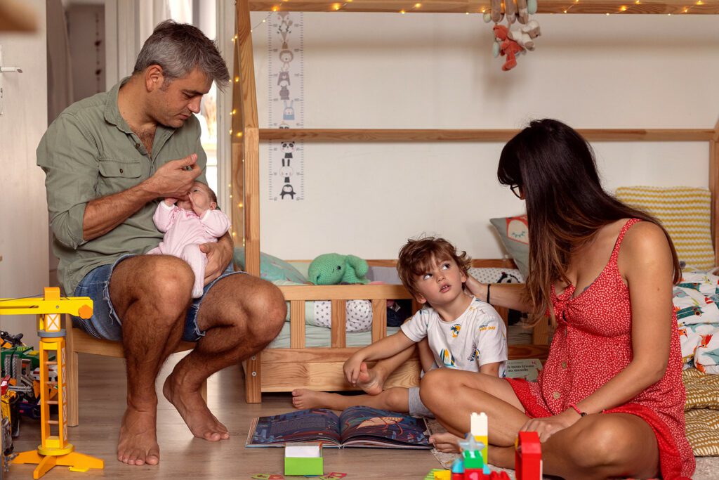 family playing with kids on the floor