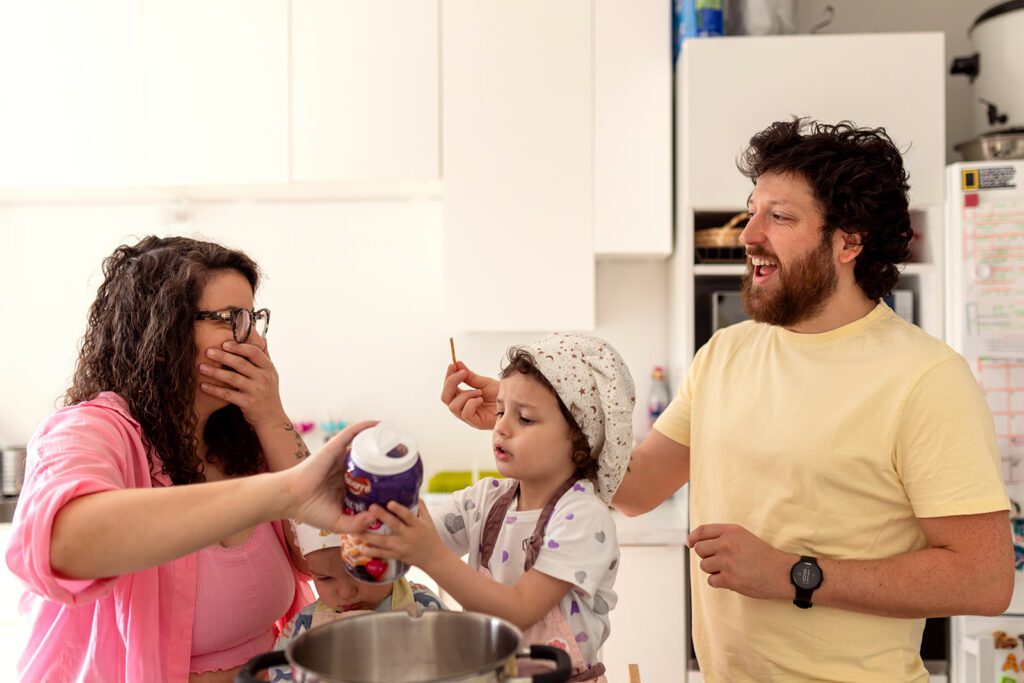 a family joyfully baking cookies