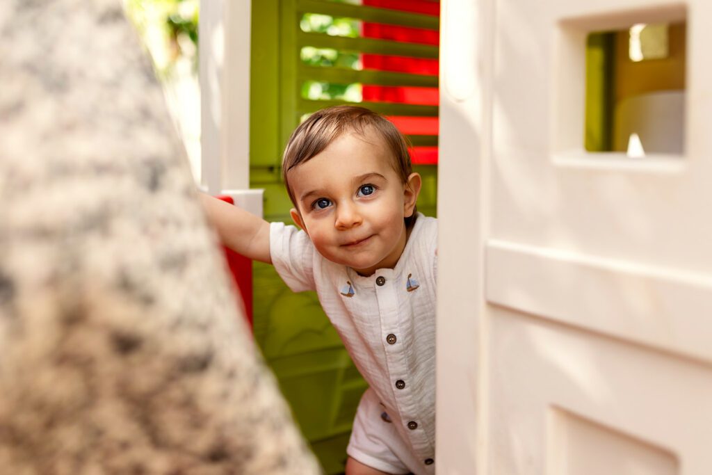 toddler playing in a playhouse