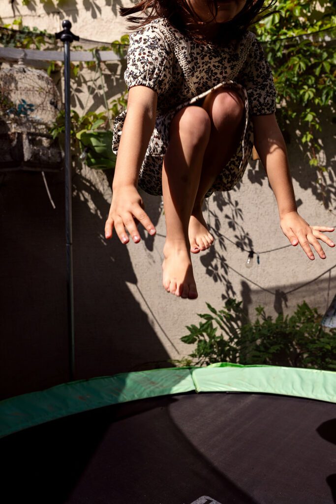 kid jumping on a trampoline