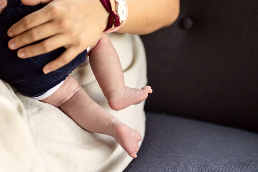 a mother holding her newborn baby during a Newborn photography session