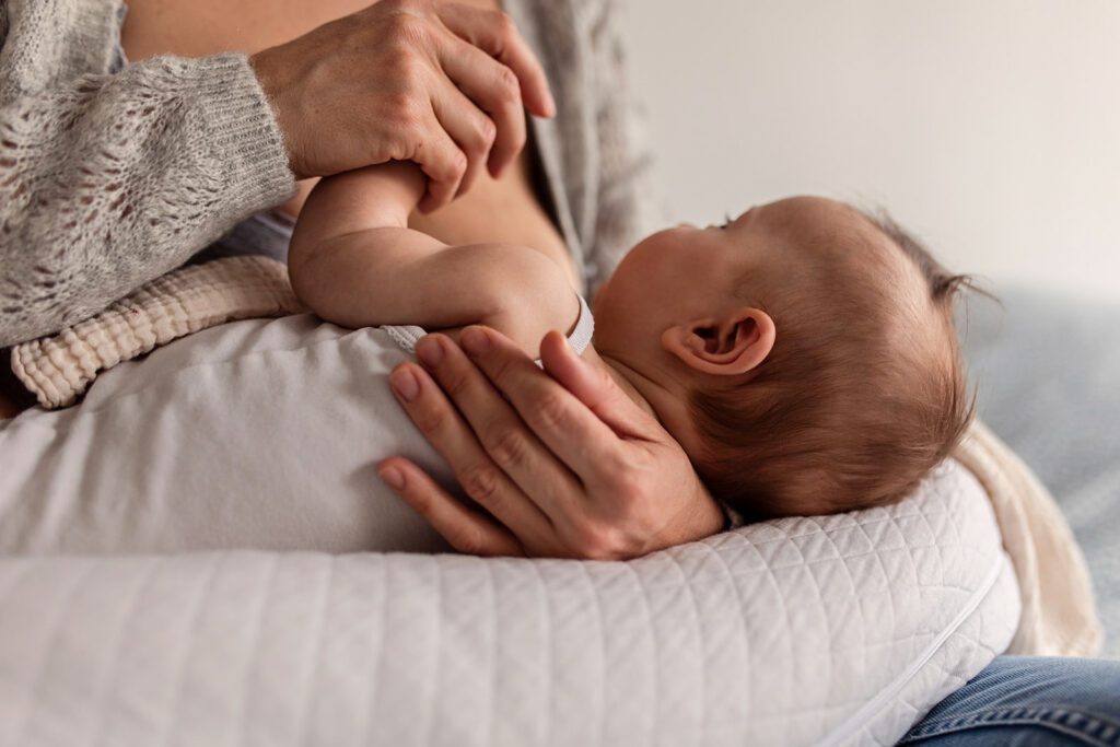 a mother holds her baby in her arms during a Baby photography session