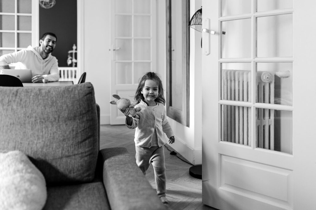little girl running happily in her home