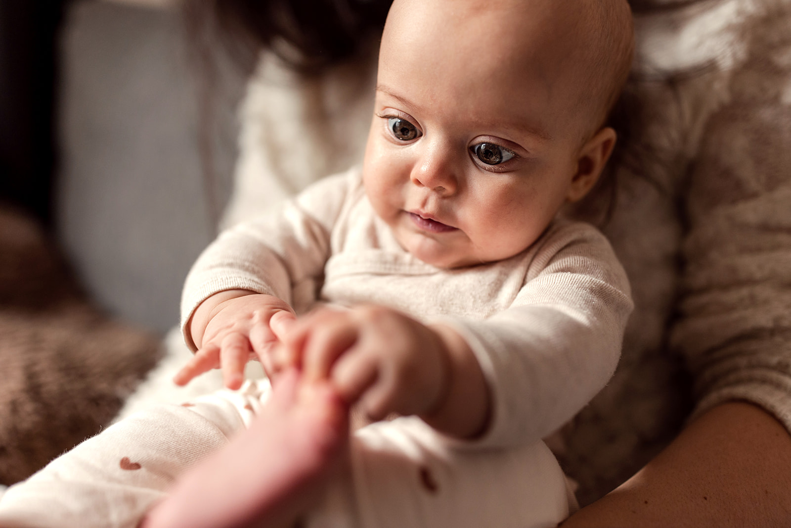 a baby is holding her foot