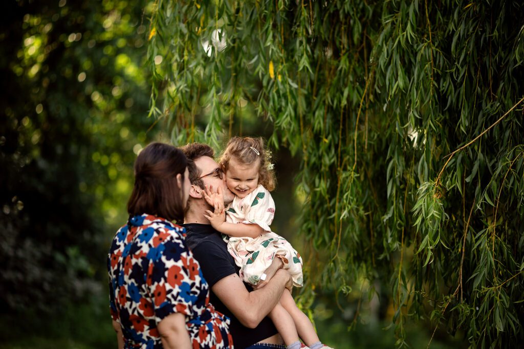 a family is playing in the park during an Outdoor photo session