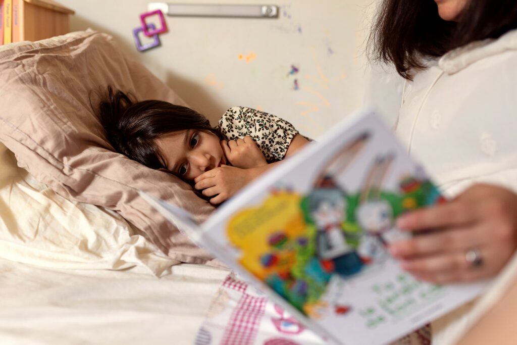 a mother reads a book to her child