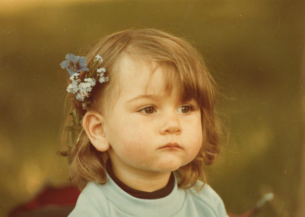 vintage portrait of a child with flowers in her hair