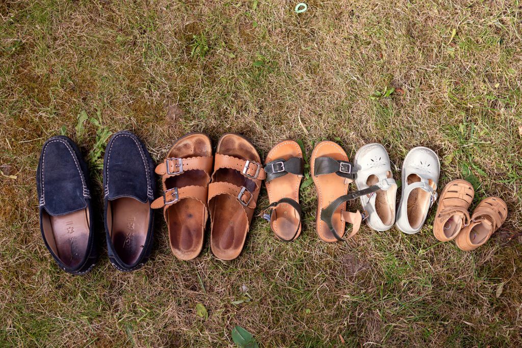Family shoes lined up on the grass