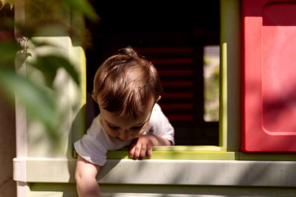 baby playing in a playhouse