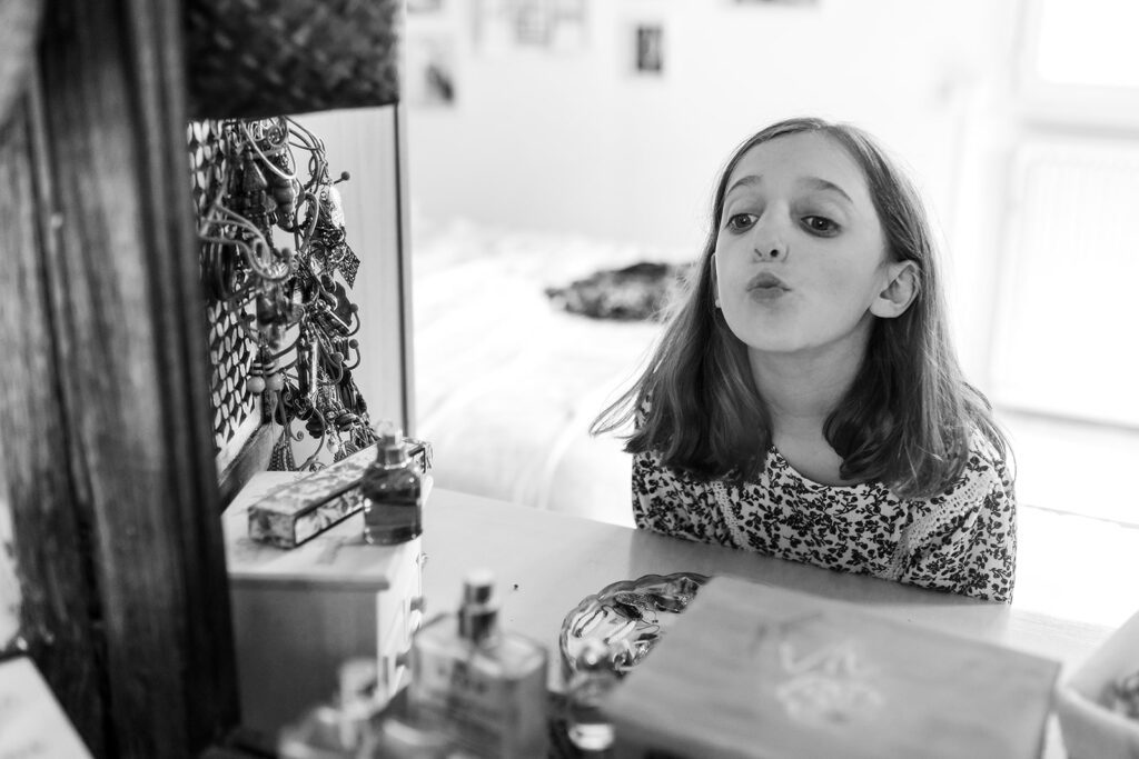 little girl looking at her reflection in a mirror