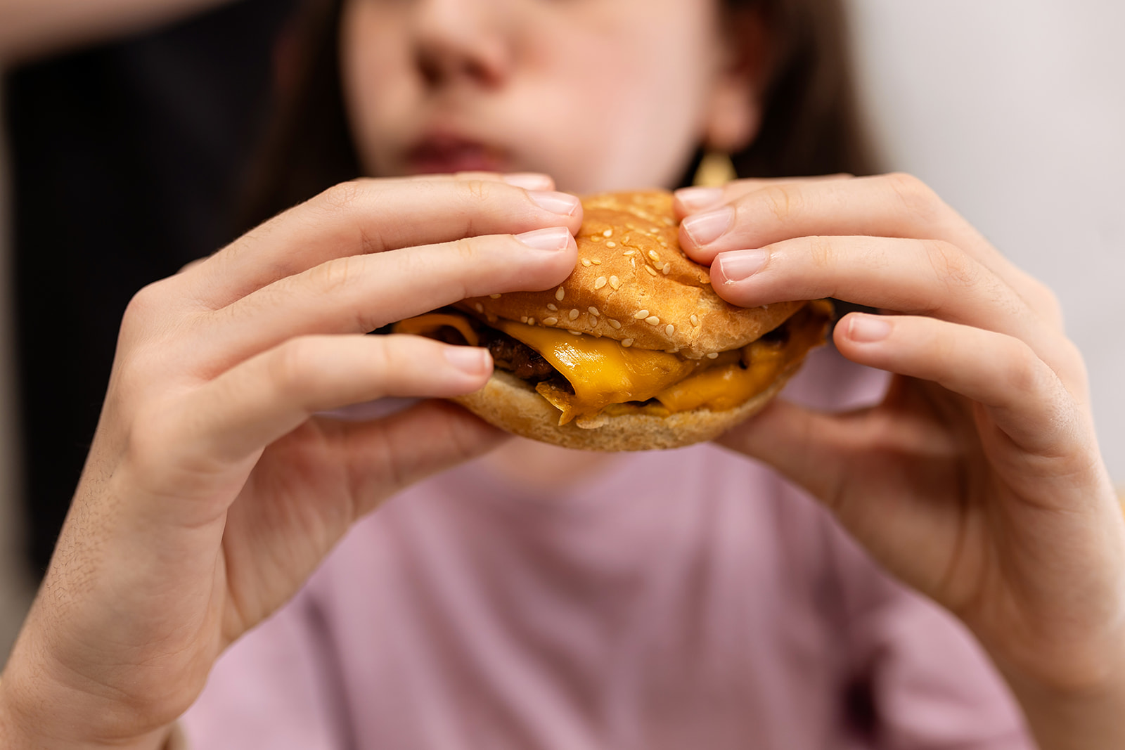 Child eating a burger during a family day out in Paris