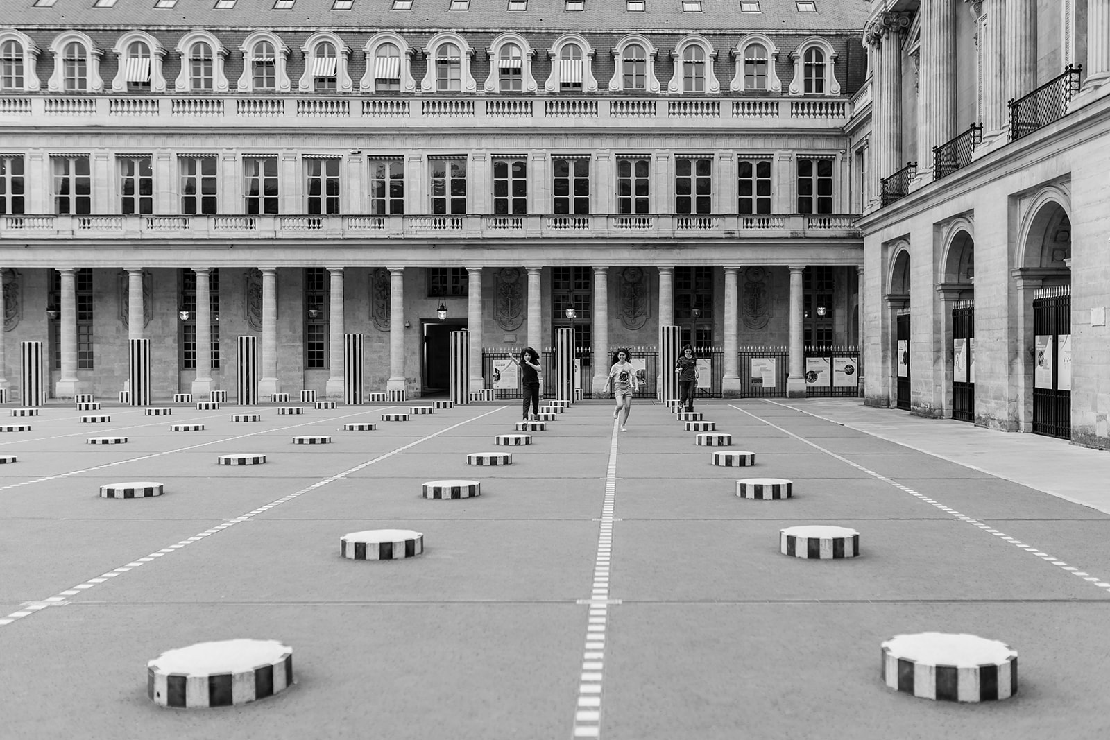 Child running through a Paris courtyard
