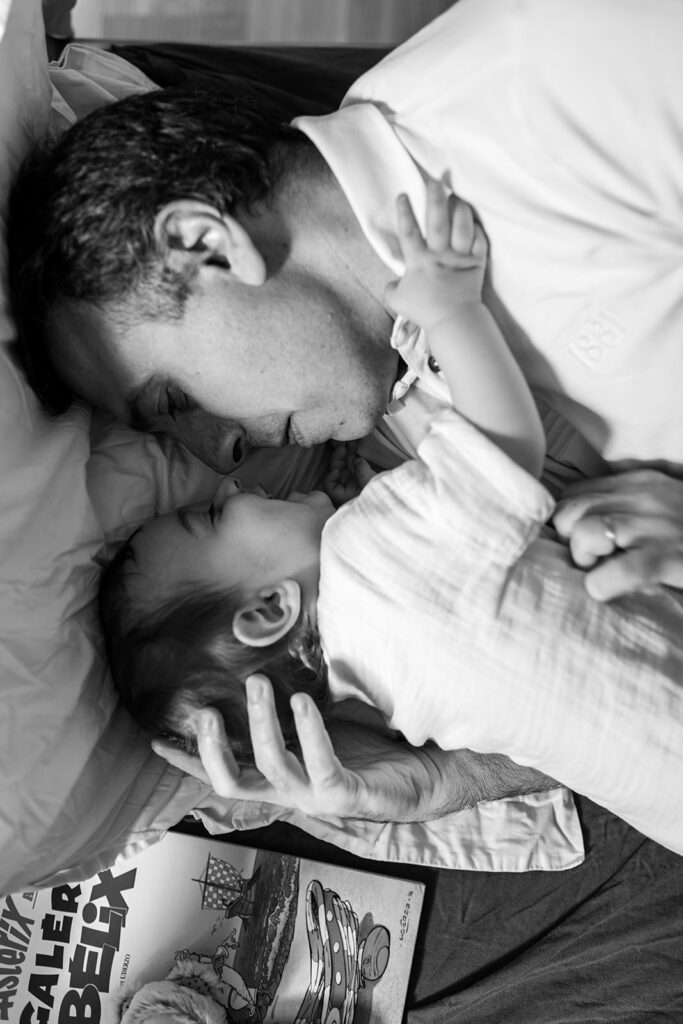 a father cuddling his baby, Why professional family photos are worth the investment