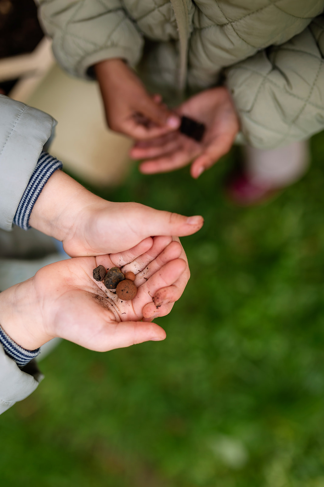 hands of a child holding rocks