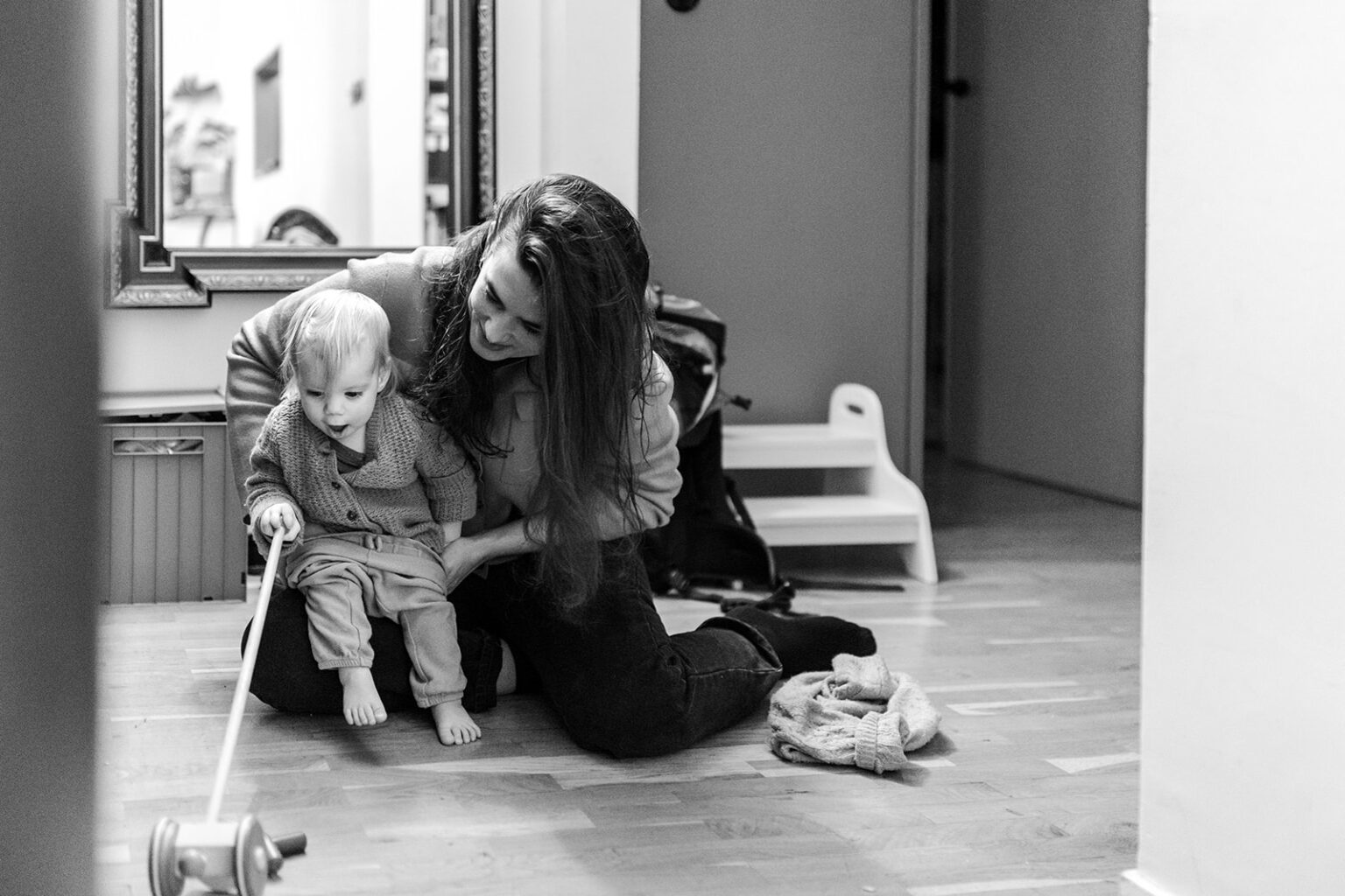 a mother helping her toddler get dressed, Everyday family moments photography