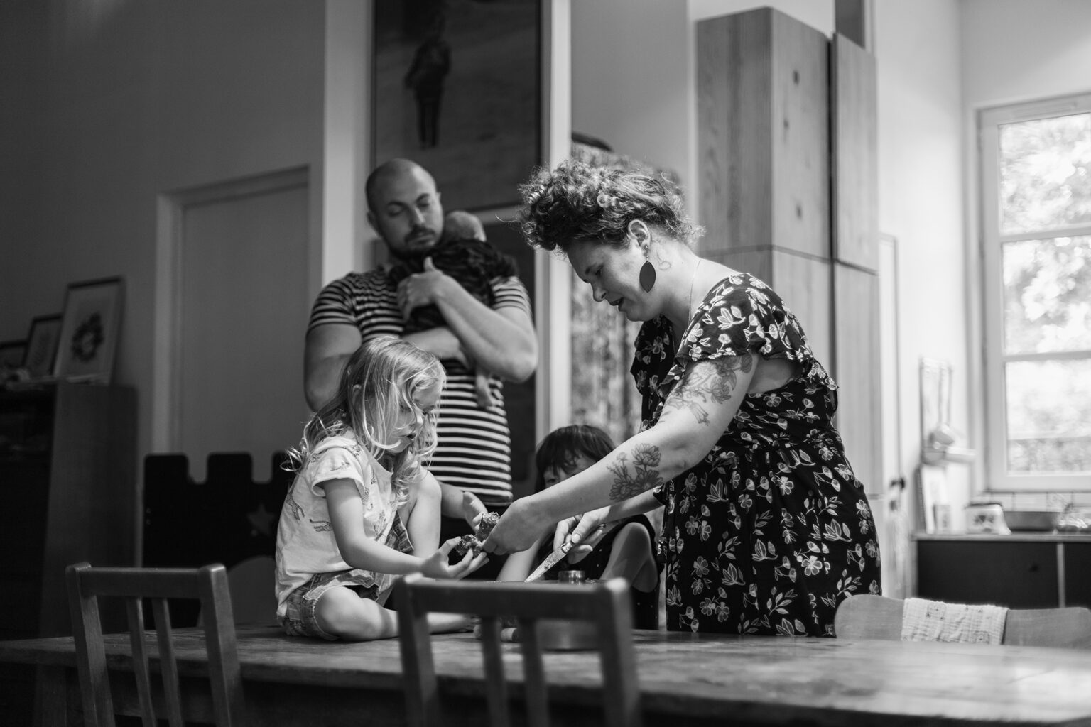 a family is sharing a cake in their home