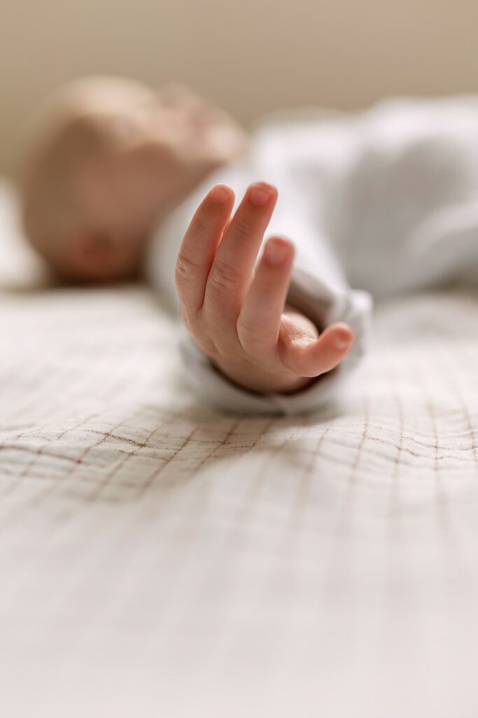 details of a little baby's hand close up, photographed by a documentary family photographer