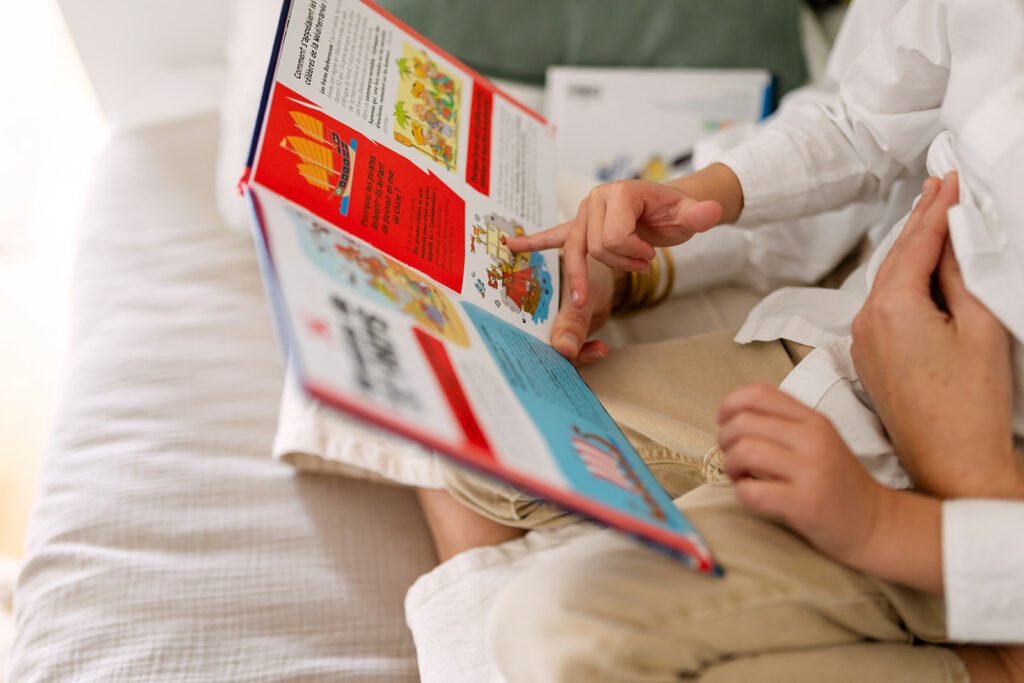 details of a mother reading a book to her child