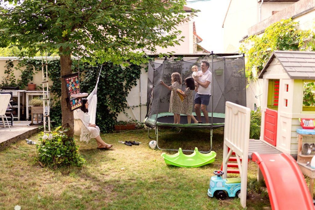 family playing on the trampoline at home