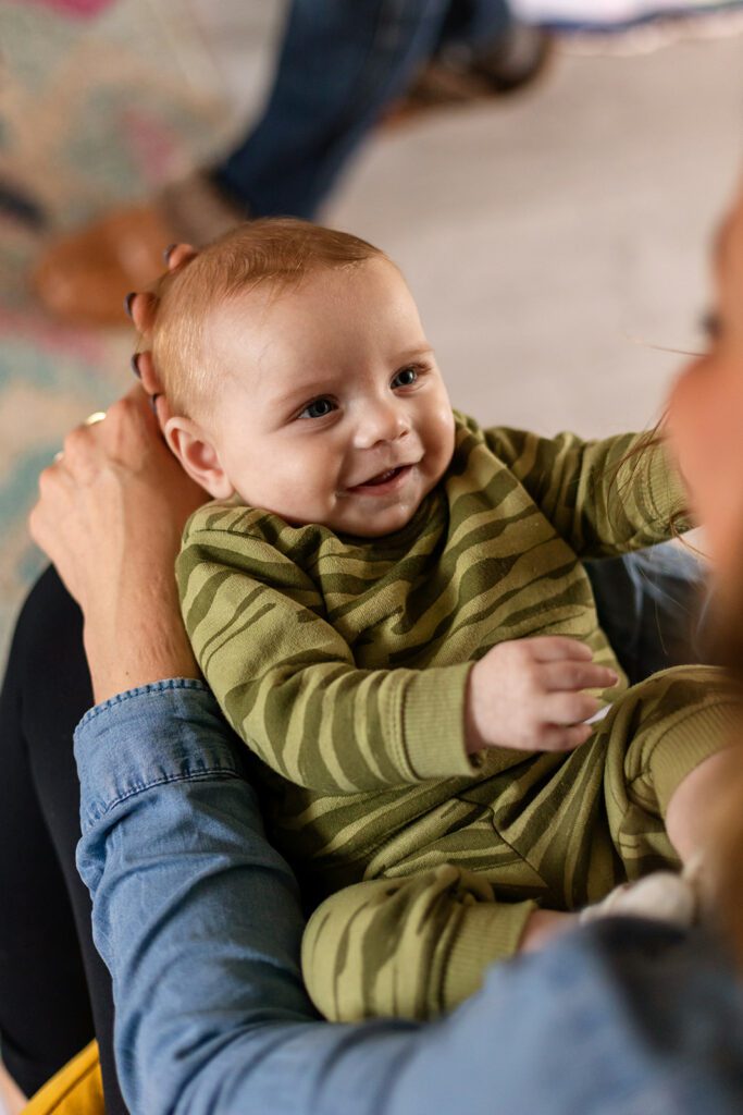 a baby looks at his mother smiling