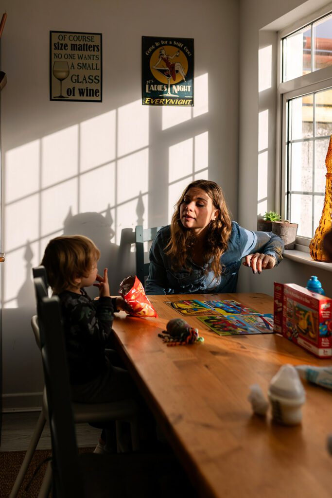 a mother sitting at the kitchen table with her son during a Dublin family photoshoot