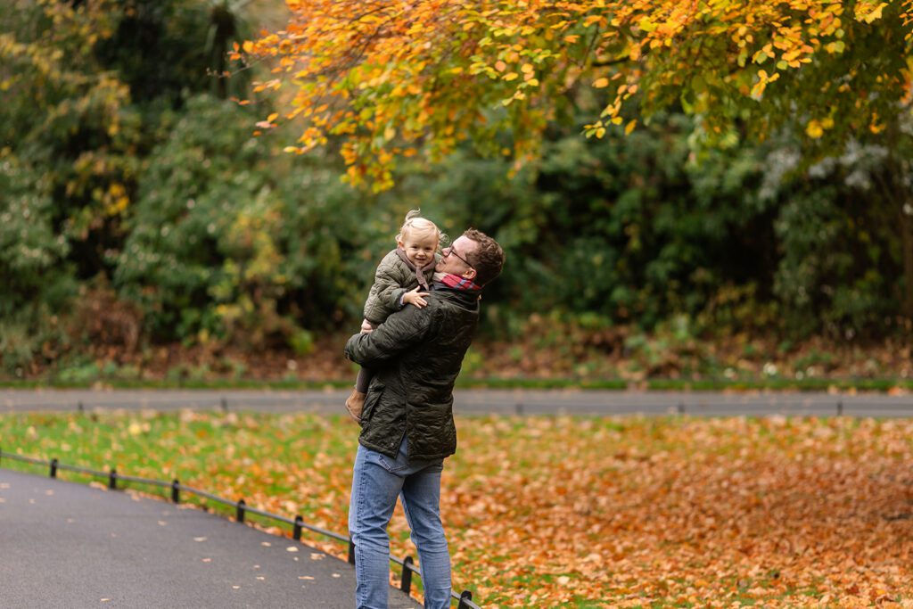 father holding his toddler in saint stephen green's park