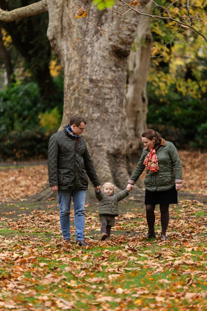 a family walking and holding hands during a Saint Stephen's Green family photo session