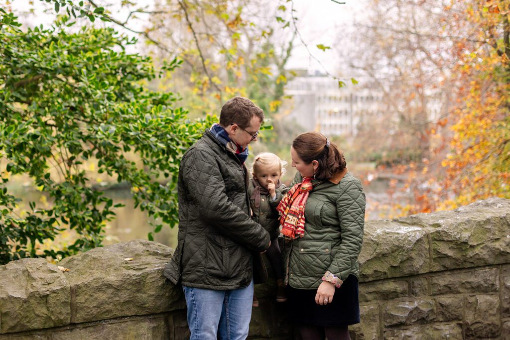 family posing by the bridge for a Saint Stephen's Green family photo session