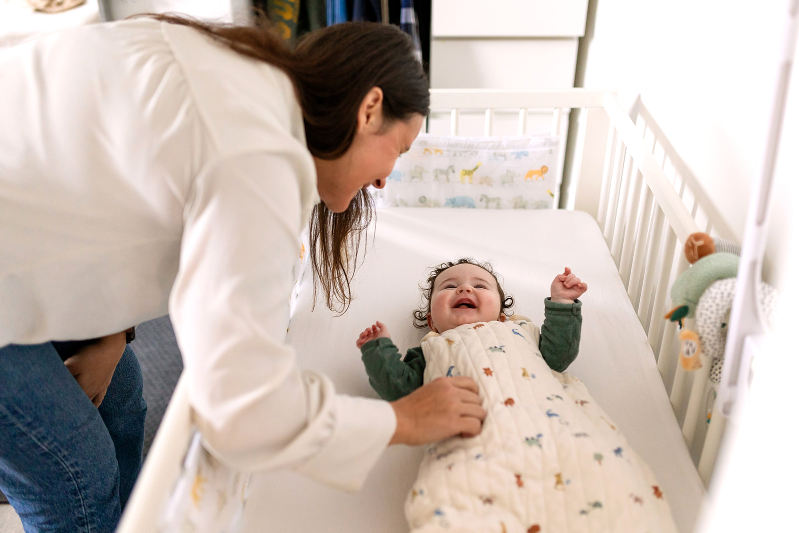 documentary family portrait of a mother greeting her baby after naptime