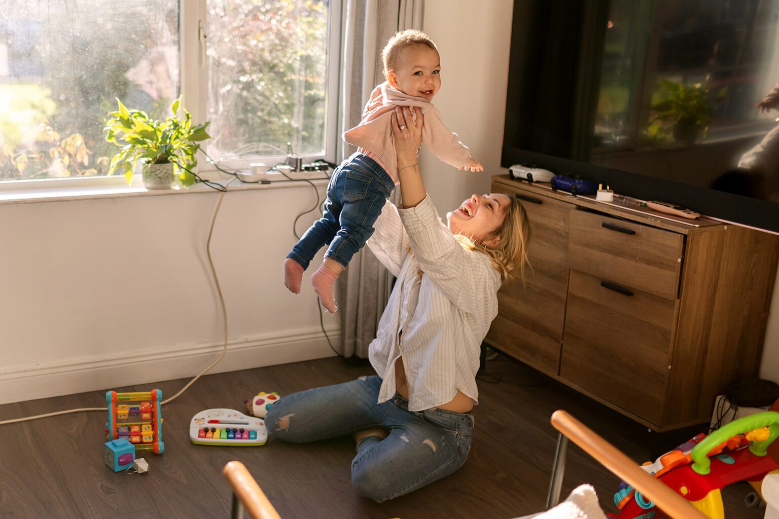 mother playing with her toddler at home. Top 50 reasons to book your next family photoshoot now