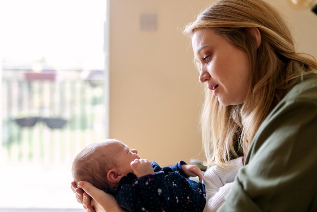 mother gazing at newborn baby