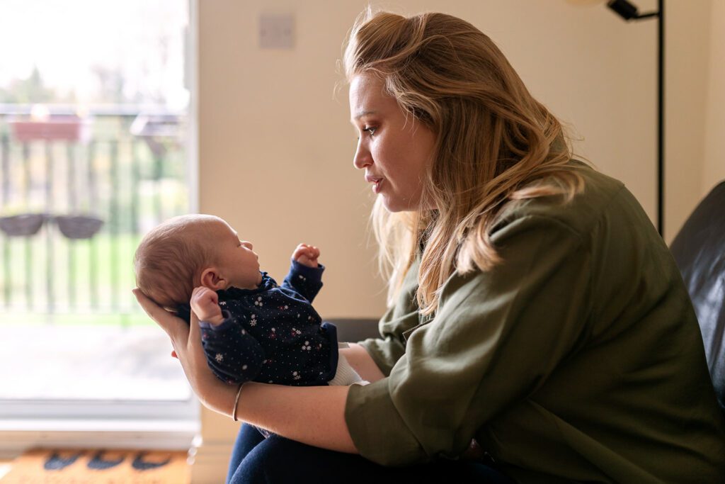 a mother gazing at her newborn