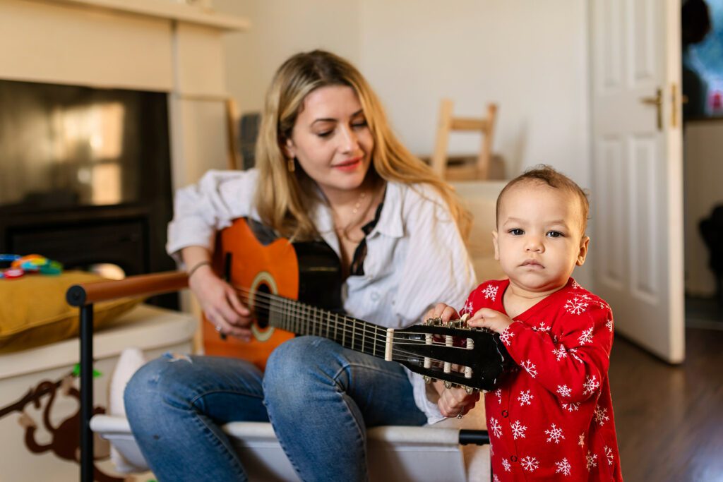 mom playing guitar for her toddler