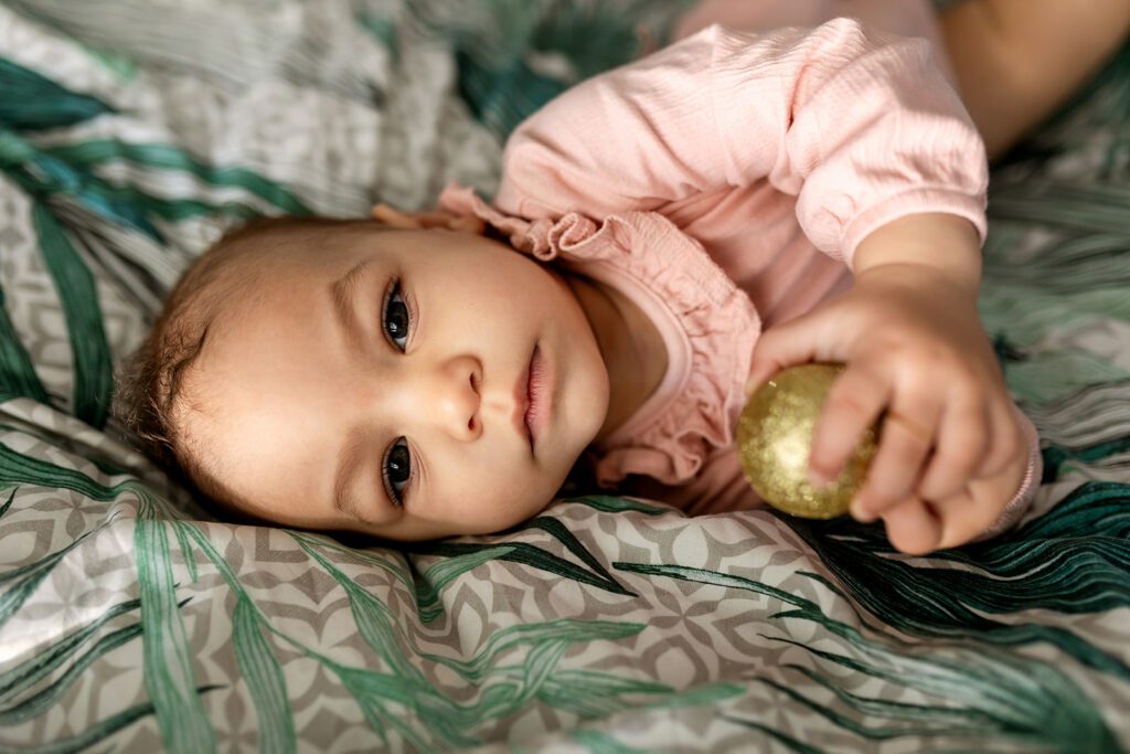 baby relaxing on the bed at home, comfortable family photo shoot