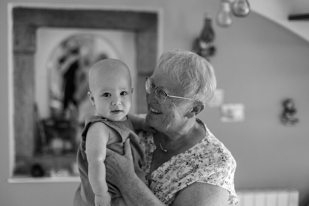 grandmother holding her grandson and smiling