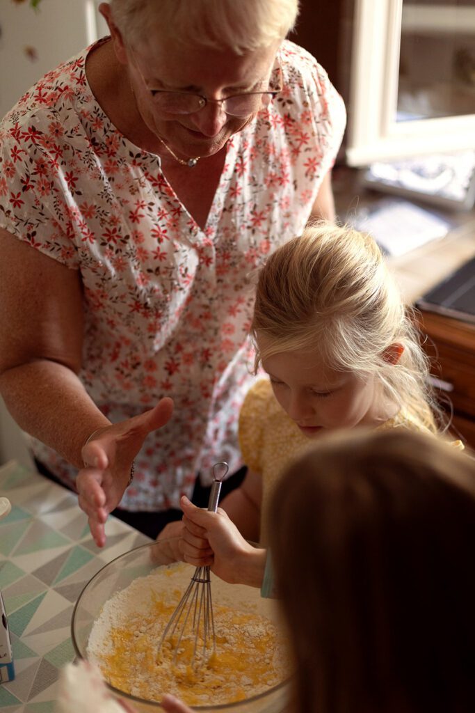 grandmother baking at home with her granddaughter