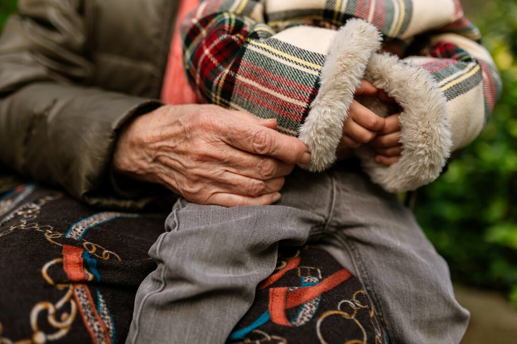 hands of a grandma holding her grandkid