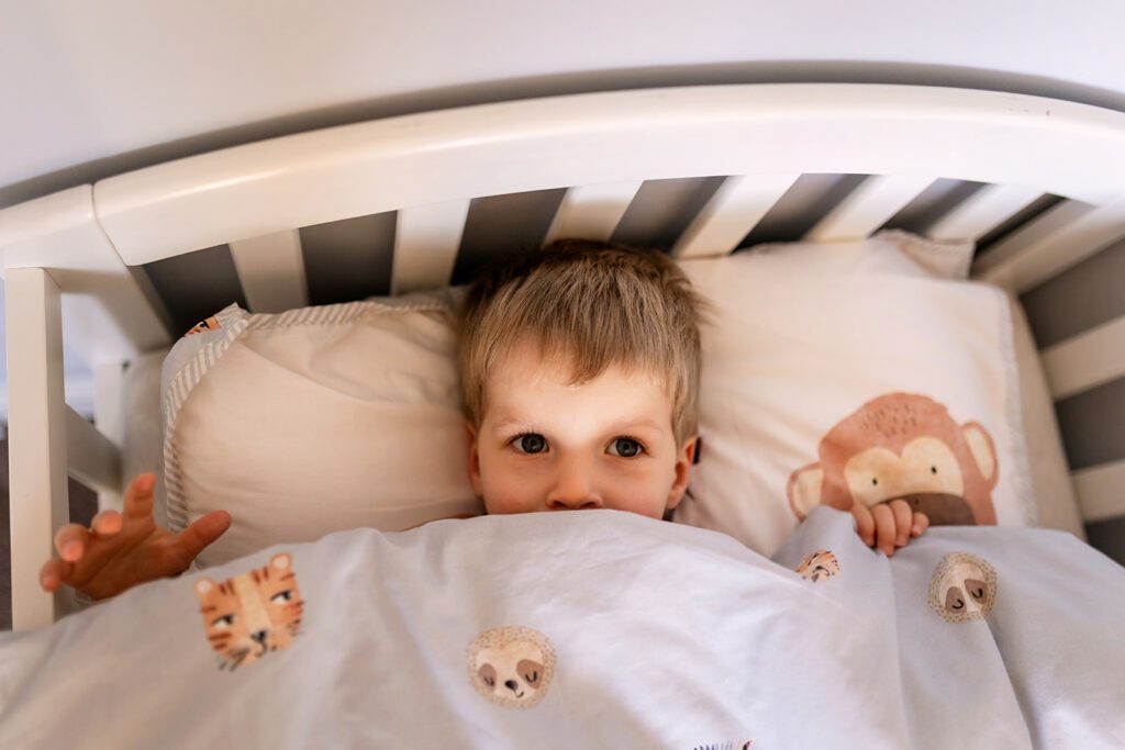 toddler in his bed