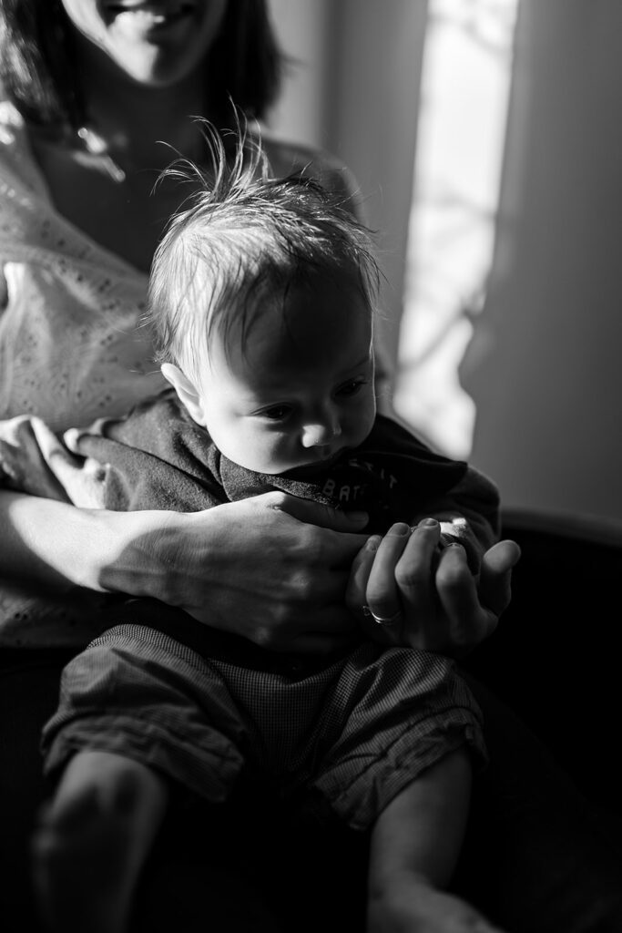 mother cuddling baby, Why professional family photos are worth the investment